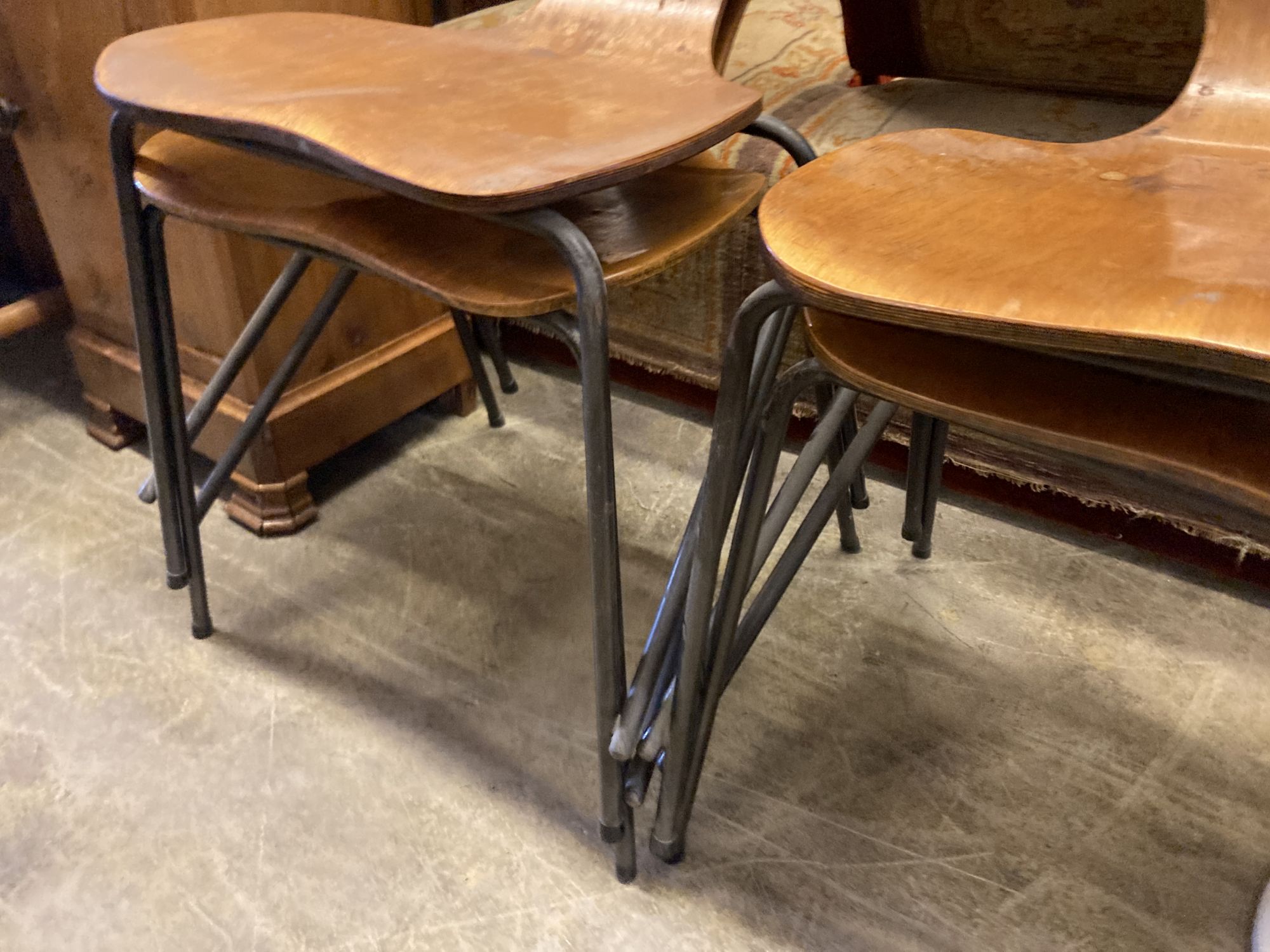 A set of four Jacobsen style bent-ply and tubular metal stacking dining chairs, width 44cm, depth 42cm, height 86cm